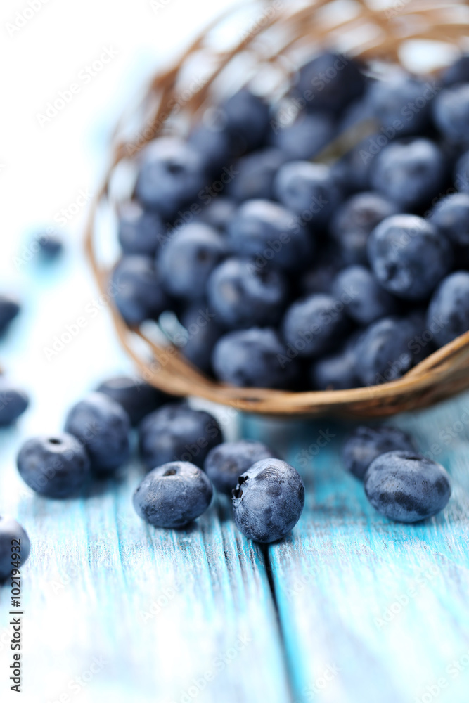 Blueberries in basket on a blue wooden table Blueberries in basket on a blue wooden table