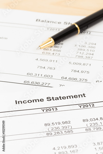 Income statement financial report with pen, documents are mock-u