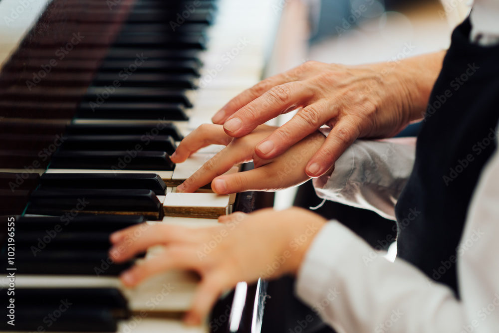 Fototapeta premium music teacher helps student to play correctly