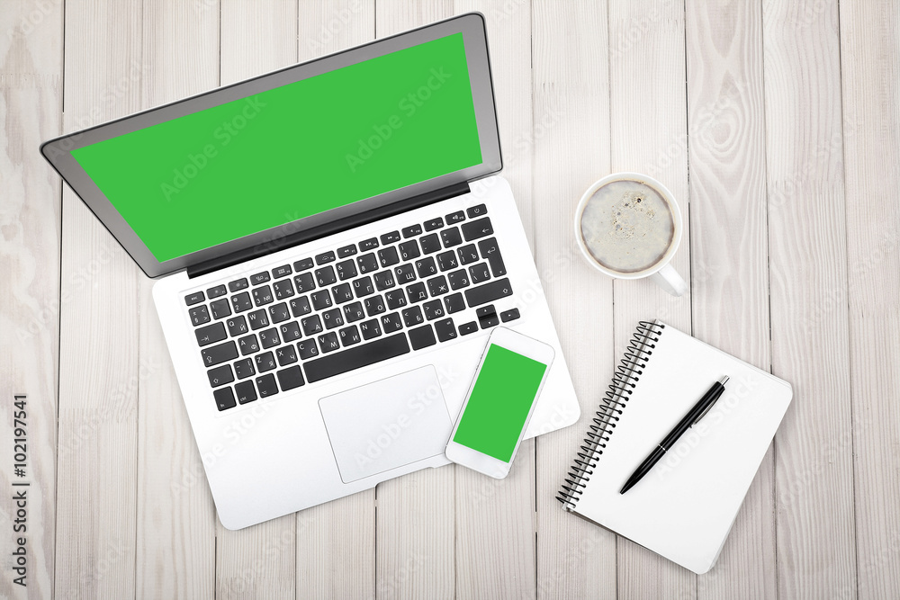 Open notebook, digital tablet and smart phone on wooden background, top view Open notebook, digital tablet and smart phone on wooden background, top view