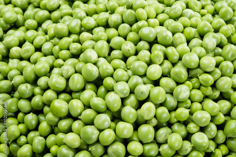 Fresh peas. Green background.