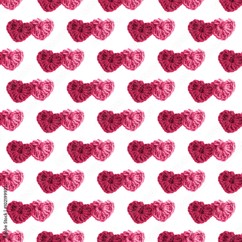 Two hand made crochet knit Red Heart and Pink Heart on white background. Valentines Day, Wedding knitting seamless pattern with hearts.