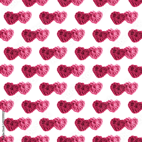 Two hand made crochet knit Red Heart and Pink Heart on white background. Valentines Day, Wedding knitting seamless pattern with hearts. photo