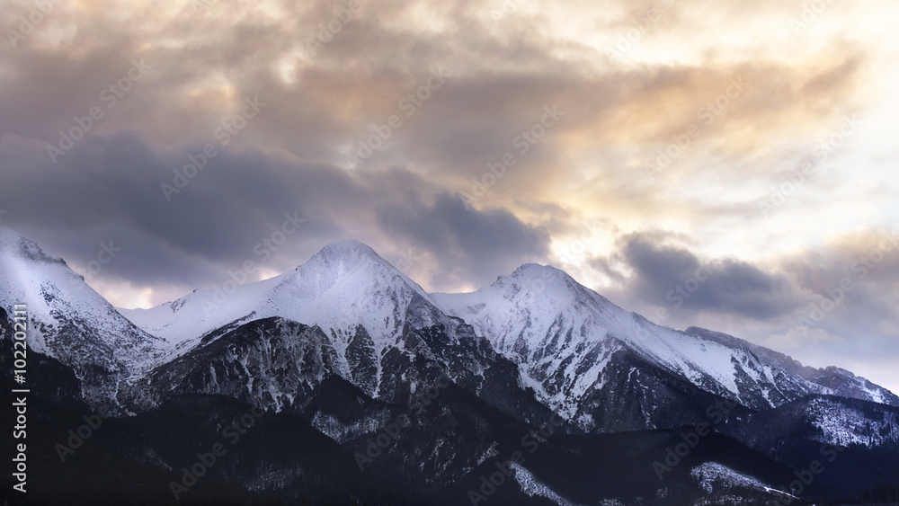 Mountain peaks with dramatic clouds and sky
