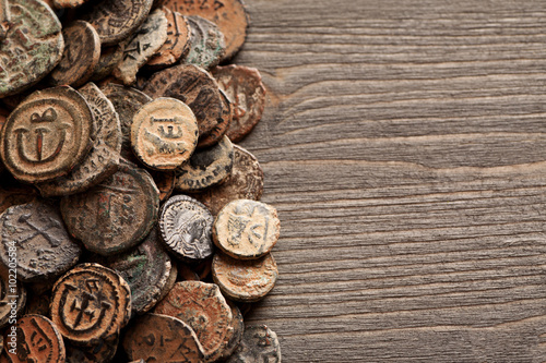 Ancient Byzantine copper coins on the old wooden table