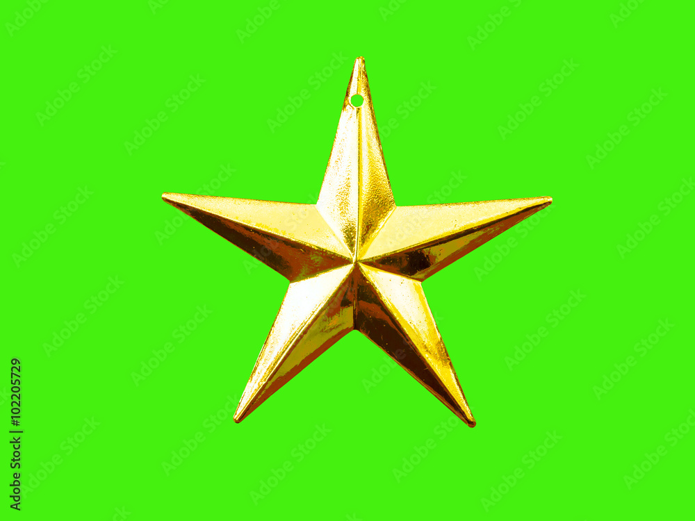 Obraz premium Golden five pointed star Christmas decoration for haging on tree on green background.