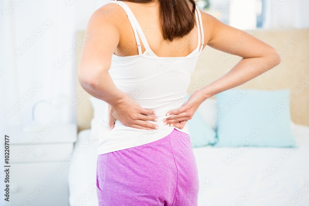Rear view of a woman with back pain