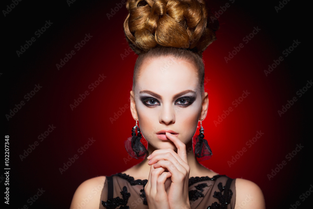 Fototapeta premium Hot young woman model with sexy lips makeup, strong eyebrows, clean shiny skin and bun hairstyle. Beautiful fashion portrait of glamour female face