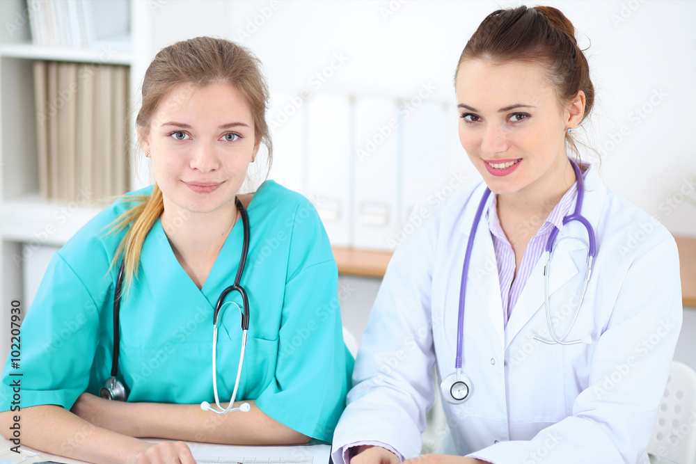 Female doctor and young surgeon intern in hospital Female doctor and young surgeon intern in hospital