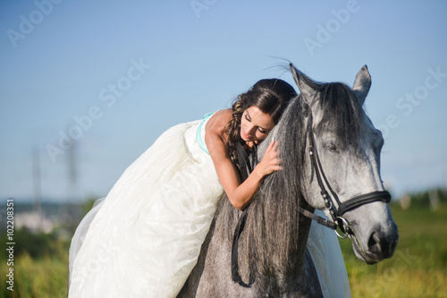Beautiful bride, sleeping on a horse in the nature