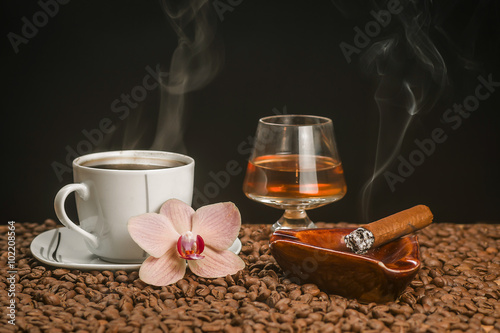 Hot coffee, lit a cigar, drink and orchid