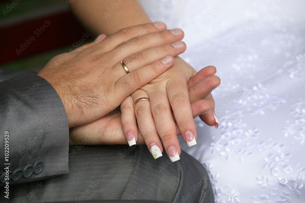 bride and groom show their hands wearing wedding rings bride and groom show their hands wearing wedding rings