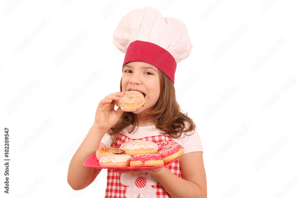 little girl cook eating sweet donuts little girl cook eating sweet donuts