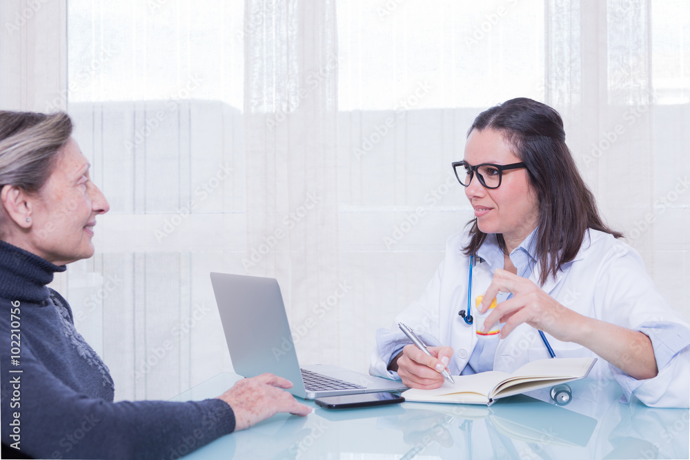 Doctor and patient talking in consulting room Doctor and patient talking in consulting room