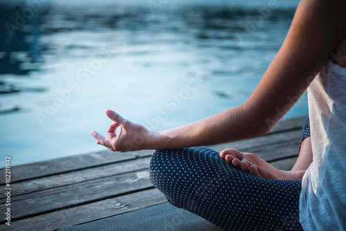 Canvas Print Meditation detail. Woman meditating by the lake