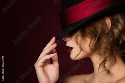 Fototapeta Portrait of young pretty woman with dark red lips wearing black