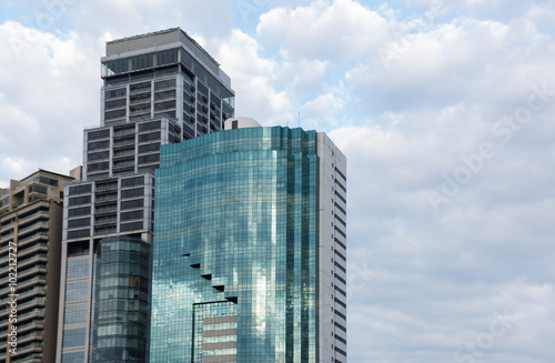 Modern glass silhouettes skyscraper against sky