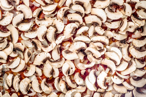 Texture of mushrooms champignon sliced and tomato sauce