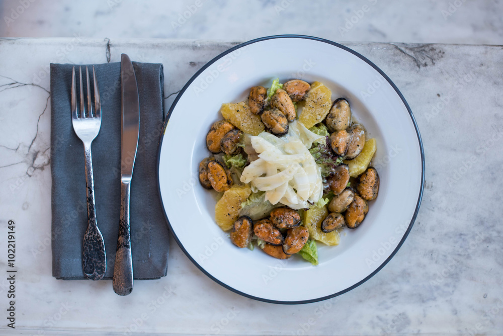 Mussels with garlic potatoes and sauce on a plate Mussels with garlic potatoes and sauce on a plate