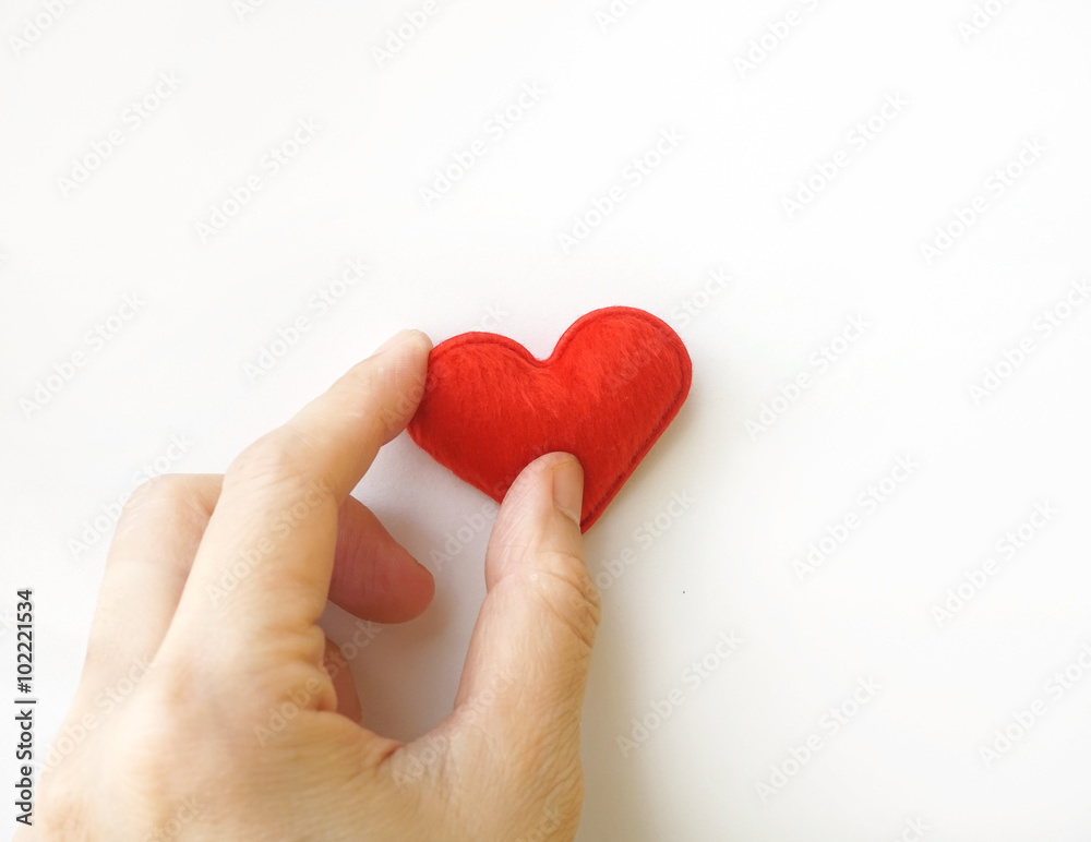 hand put red heart on white background hand put red heart on white background