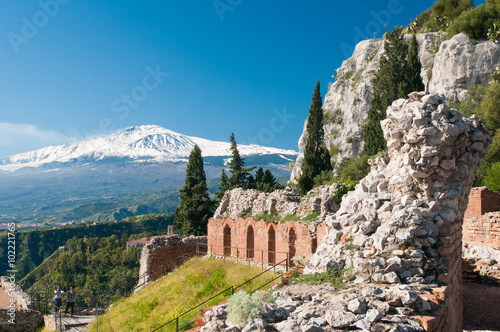 Section of the upper perimetral arcade of the greek theater of Taormina, Sicily, with snowy mount Etna in the background