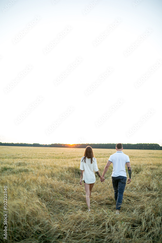 Couple in love - Beginning of a Love Story. A man and a girl with a tattoo on the nature Couple in love - Beginning of a Love Story. A man and a girl with a tattoo on the nature