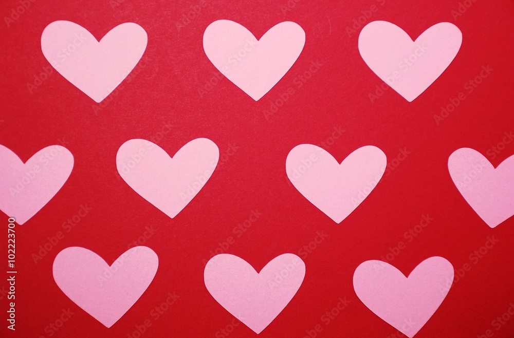 Pink hearts on a red background