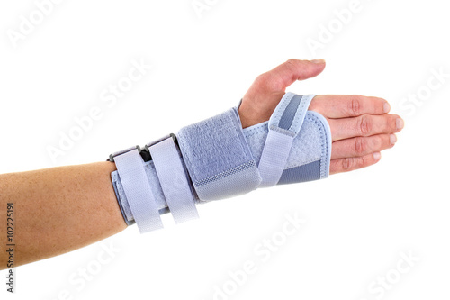 Man Wearing Supportive Wrist Brace in Studio. photo