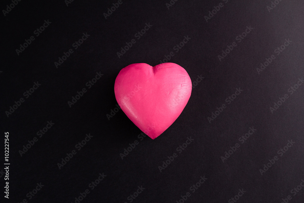 Obraz premium pink heart on a black background