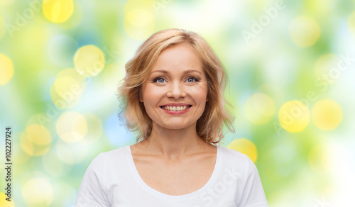 Fototapeta Naklejka Na Ścianę i Meble -  smiling woman in blank white t-shirt