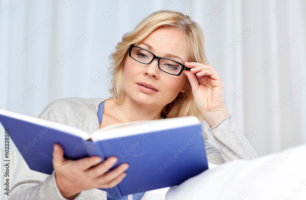woman reading book and sitting on couch woman reading book and sitting on couch
