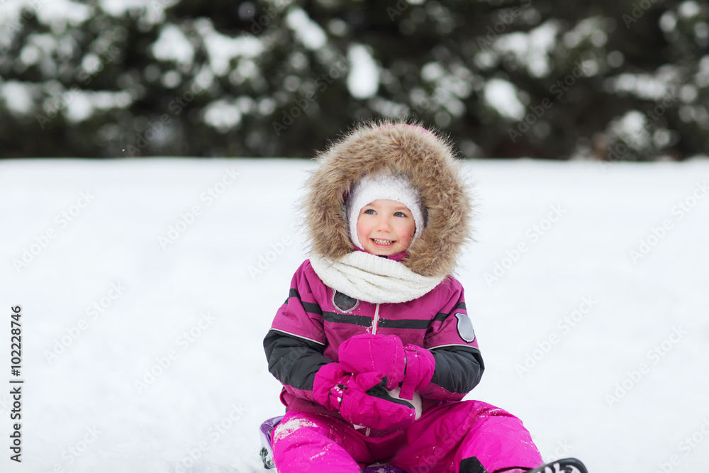 happy little kid on sled outdoors in winter happy little kid on sled outdoors in winter