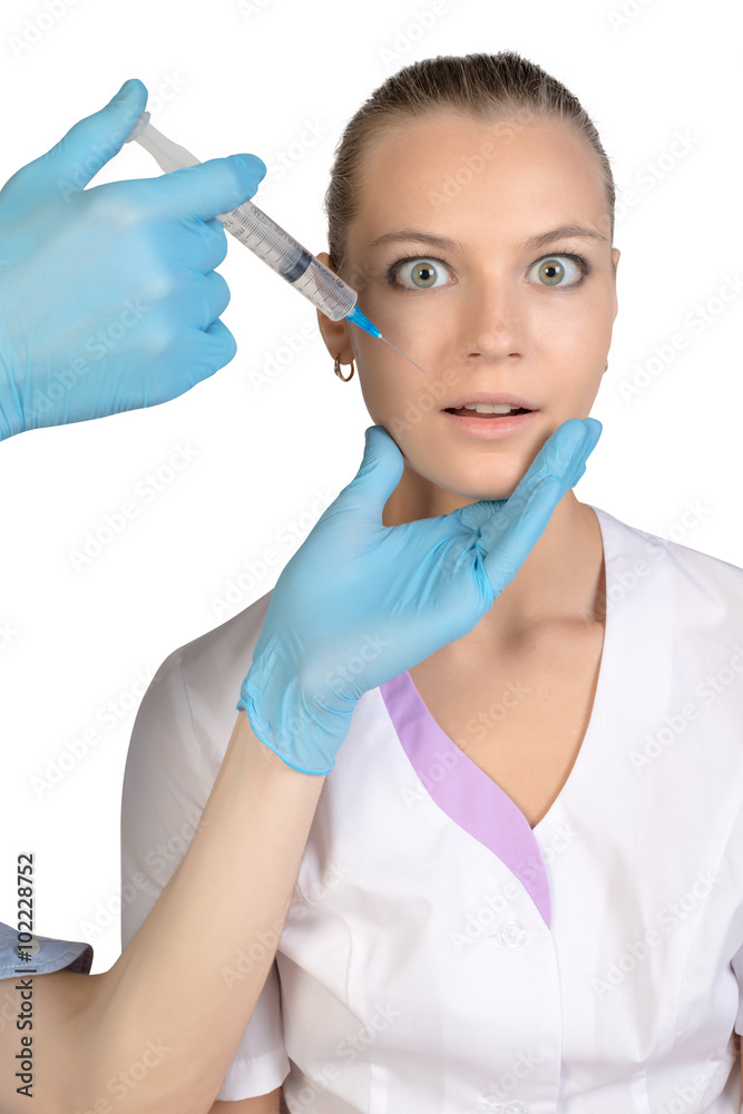Young beautiful girl getting Botox injection from a syringe Young beautiful girl getting Botox injection from a syringe