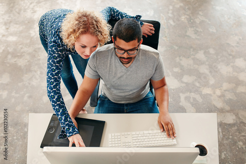 Two young designers working on a pc photo