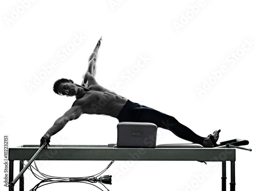 man pilates reformer exercises fitness isolated photo