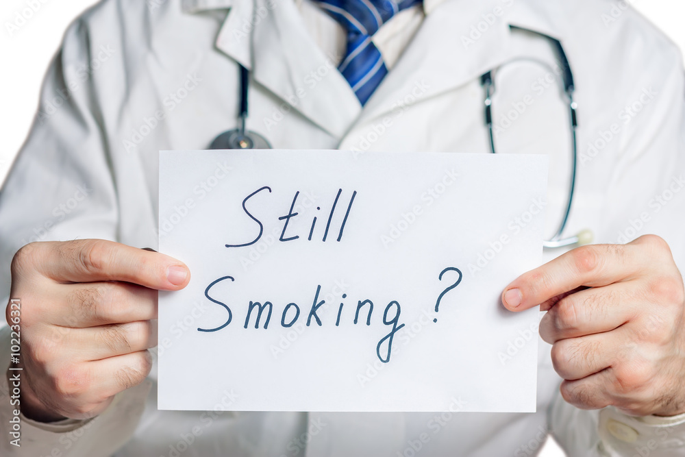 Doctor holds a clipboard with still smoking label Doctor holds a clipboard with still smoking label