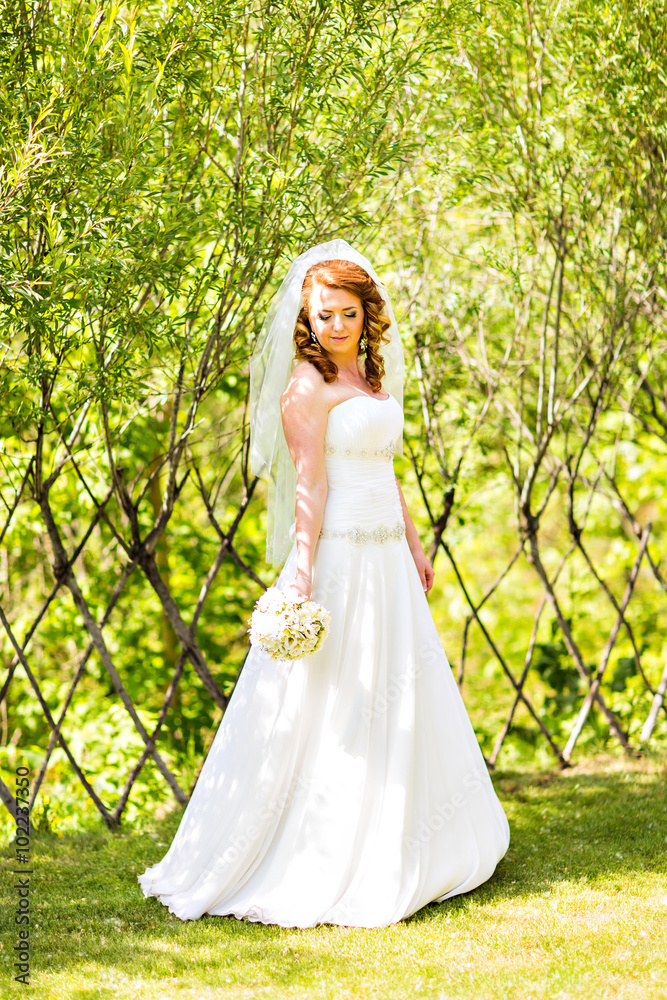 Lovely bride outdoors in a park