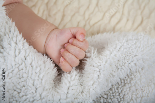 Child's hand clenched into a fist.