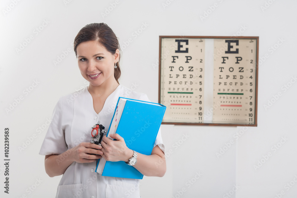 Doctor optometrist with blue book and eye chart in the backgroun