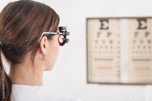 The patient is checked by sight with a special optometric instru photo