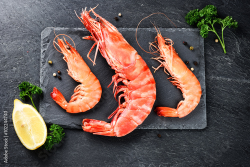 Fine selection of jumbo shrimps for dinner on stone plate photo