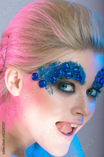  girls blonde girl with creative make-up with stones with colore