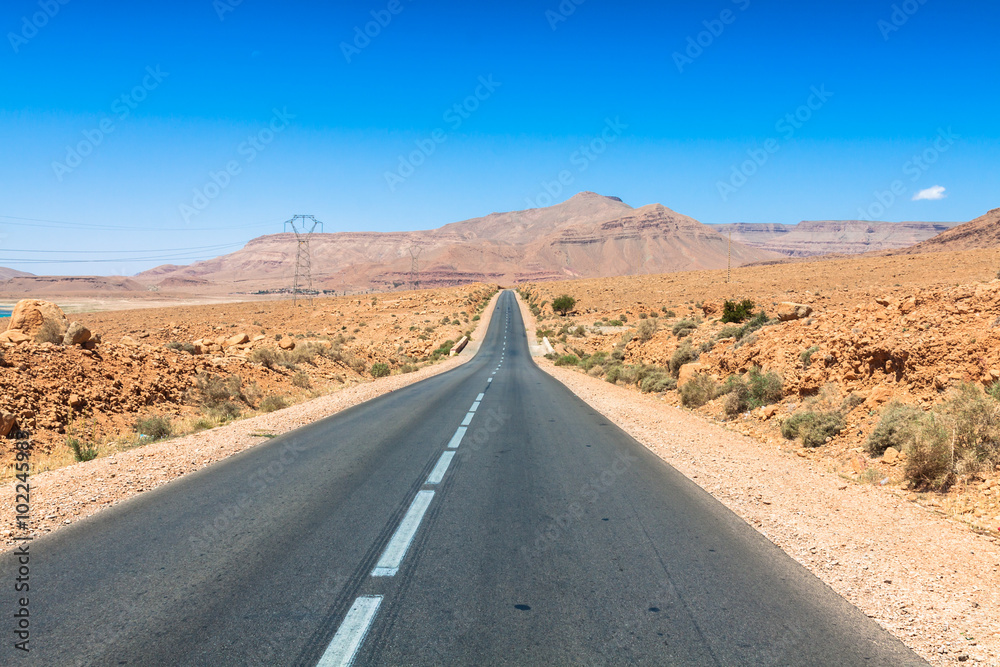 Endless road in Sahara Desert with blue sky,Morocco Africa