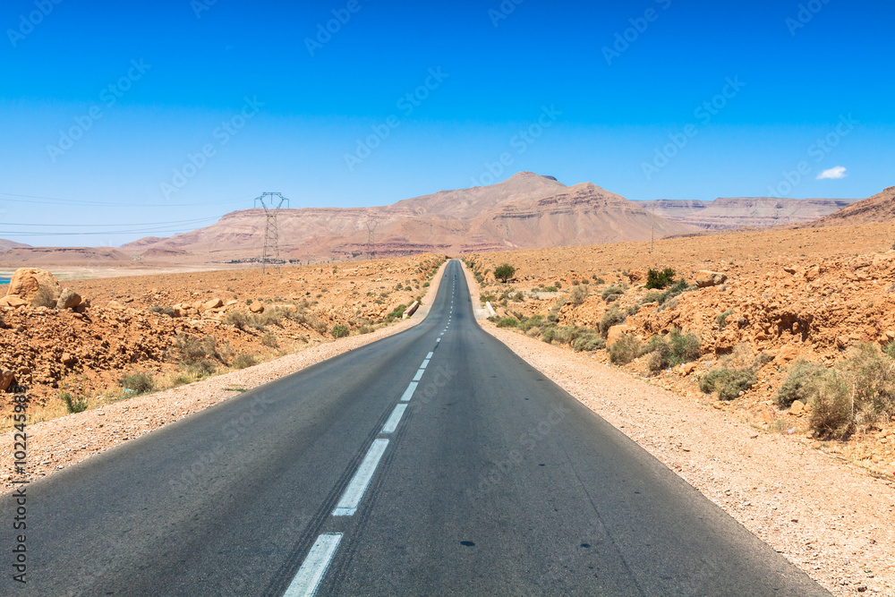Endless road in Sahara Desert with blue sky,Morocco Africa Endless road in Sahara Desert with blue sky,Morocco Africa