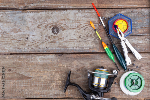 fishing tackles for anglers on wooden background