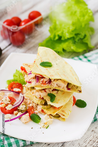 Mexican Quesadilla wrap with chicken, olives, sweet pepper and salad.