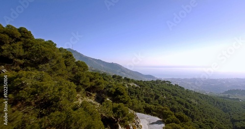 4K Aerial, Flying in the mountains with view on La Capellania, Andalusia, Spain - additionally stabilized, graded and mostly accelerated. photo