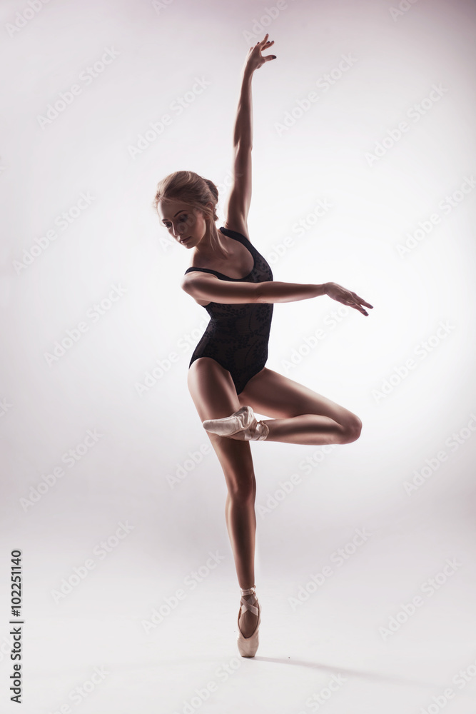 Ballerina in beige outfit posing on toes Ballerina in beige outfit posing on toes