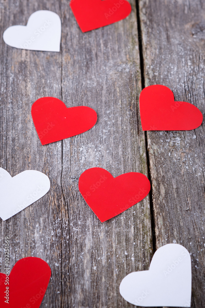Valentines Day background with red and white hearts on old woode