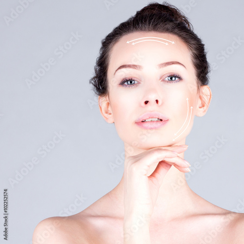 Rejuvenation program.  Portrait of beautiful woman with long neck touching chin. Lifting skin.